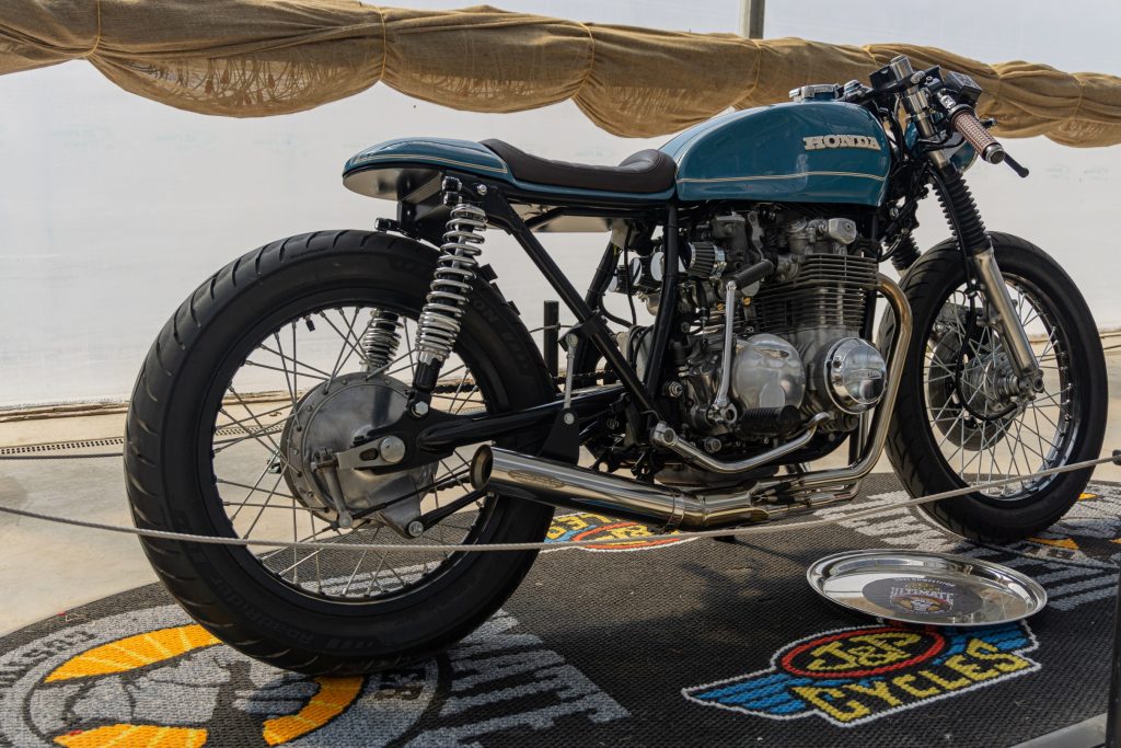 The rear 3/4 view of a blue Custom 1974 Honda CB550 cafe racer at IMS Outdoors Chicago 2021