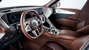 Dashboard, infotainment system, steering wheel, and leather front seats in 2023 BMW XM. Leather seats is the most popular new car feature.