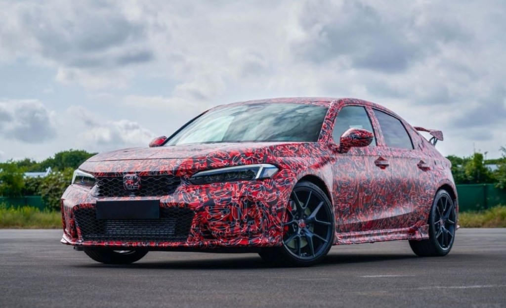 Driver's side front angle view of redesigned 2022 Honda Civic Type R wrapped in camouflage