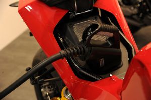 A red Energica motorcycle charging. 
