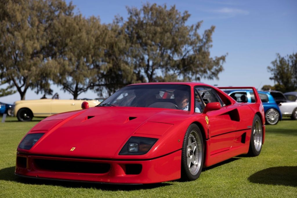 A Ferrari F40 sports car model with a red paint color option at the Celebration of the Motorcar at the Cottesloe Civic Centre Gardens in Perth, Australia
