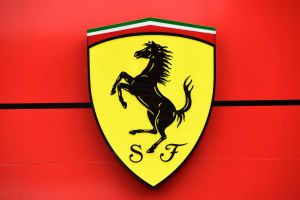 The Ferrari logo, featuring a yellow shield with a black prancing horse and the letters 'S' and 'F' below it