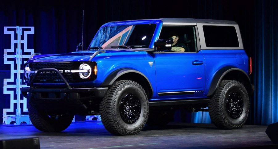 A blue Ford Bronco is on display.