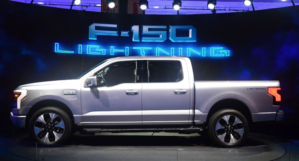 A silver Ford F-150 Lightning is on display.