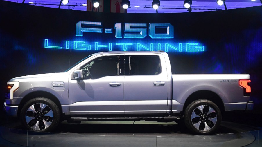 A silver Ford F-150 Lightning is on display.