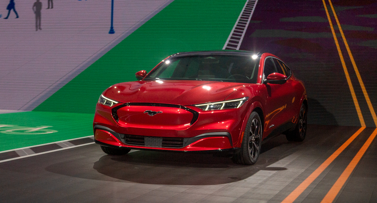 A red Ford Mustang Mach-E electric SUV.