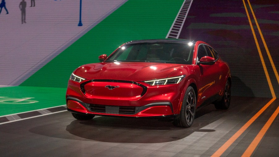 A red Ford Mustang Mach-E electric SUV.