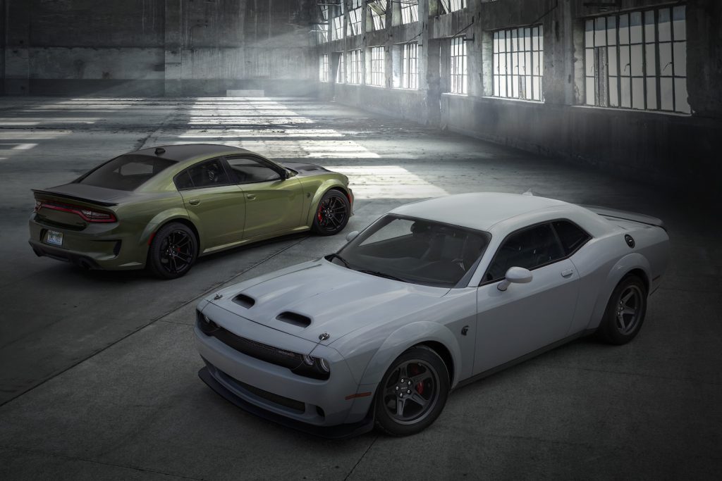 SRT HEllcat and 2022 Dodge Challenger SRT parked in a hanger. Dodge is hiring a Chief Donut Maker to drive these models around the country and rip donuts. 