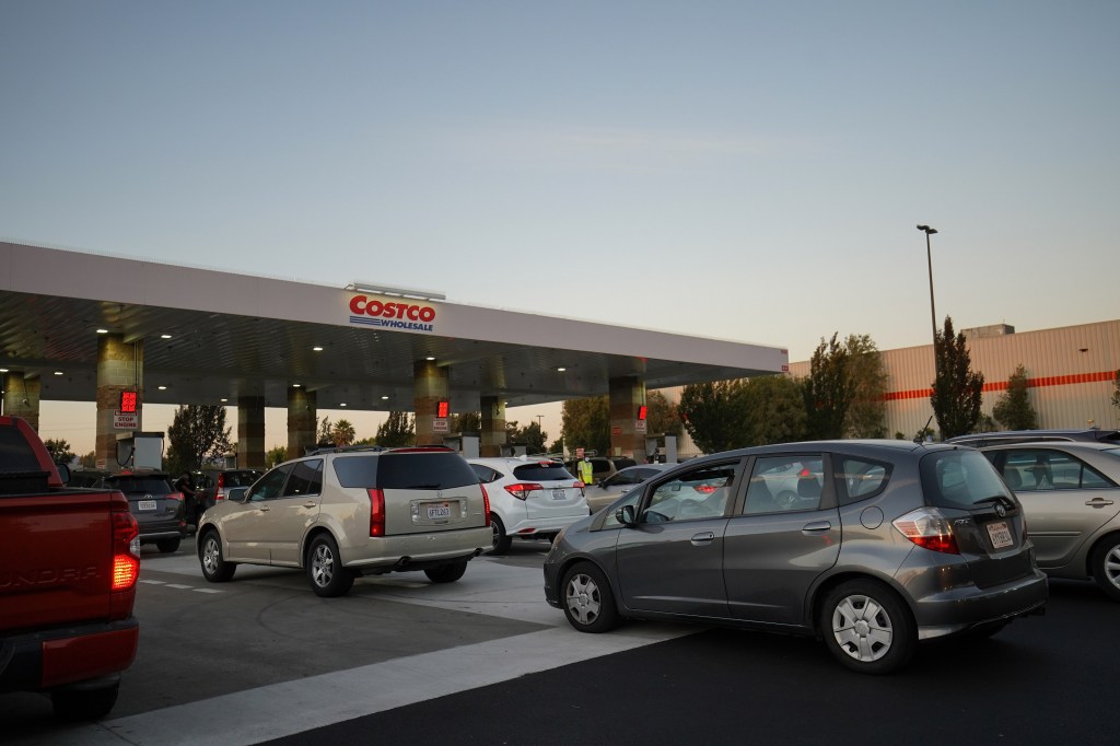A line of cars at a Costco gas station dealing with higher fuel prices
