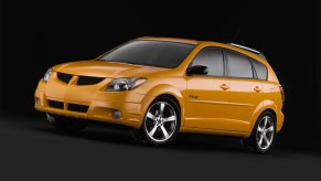 orange Pontiac Vibe against a black background. This is one of the best affordable cars you can buy under $5,000