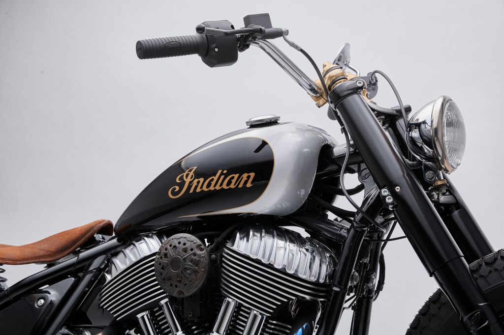 A close-up side view of Go Takamine's custom 2022 Indian Super Chief Limited's black-and-silver gas tank, handlebars, headlamp, and engine