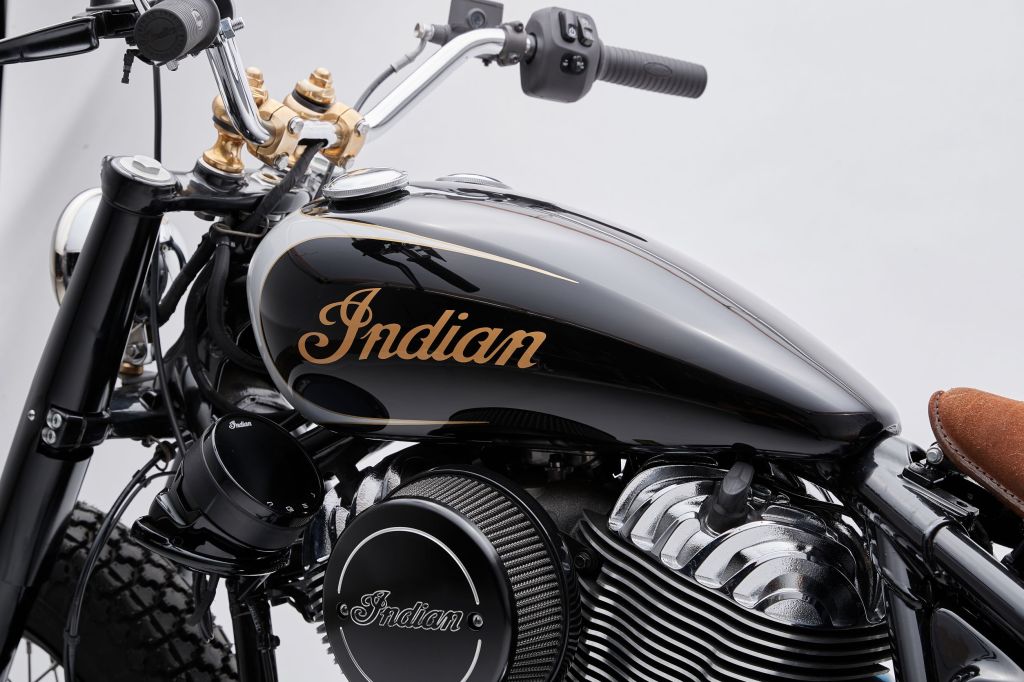A close-up rear view of Go Takamine's custom black-and-silver 2022 Indian Super Chief Limited's tank, handlebars with brass risers ,and side-mounted gauge