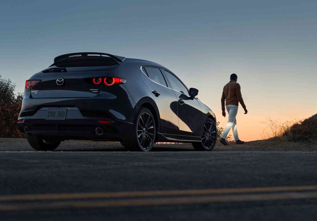 Gray 2022 Mazda3 Hatchback parked on the side of the road with the sunset in the background