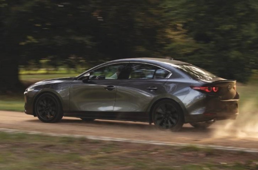 Gray 2022 Mazda3 Sedan driving on a dirt road