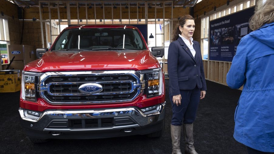 Michigan Governor Gretchen Whitemer standing in front of a Ford Pickup truck.