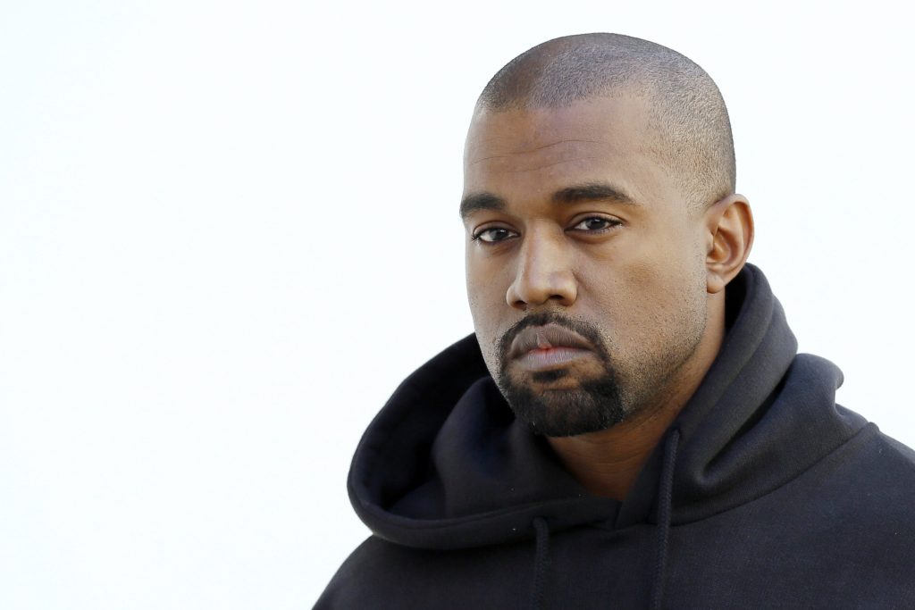 Kanye West wearing a black sweatshirt on a white background, he recently sold his Ford Raptor pickup truck Fleet