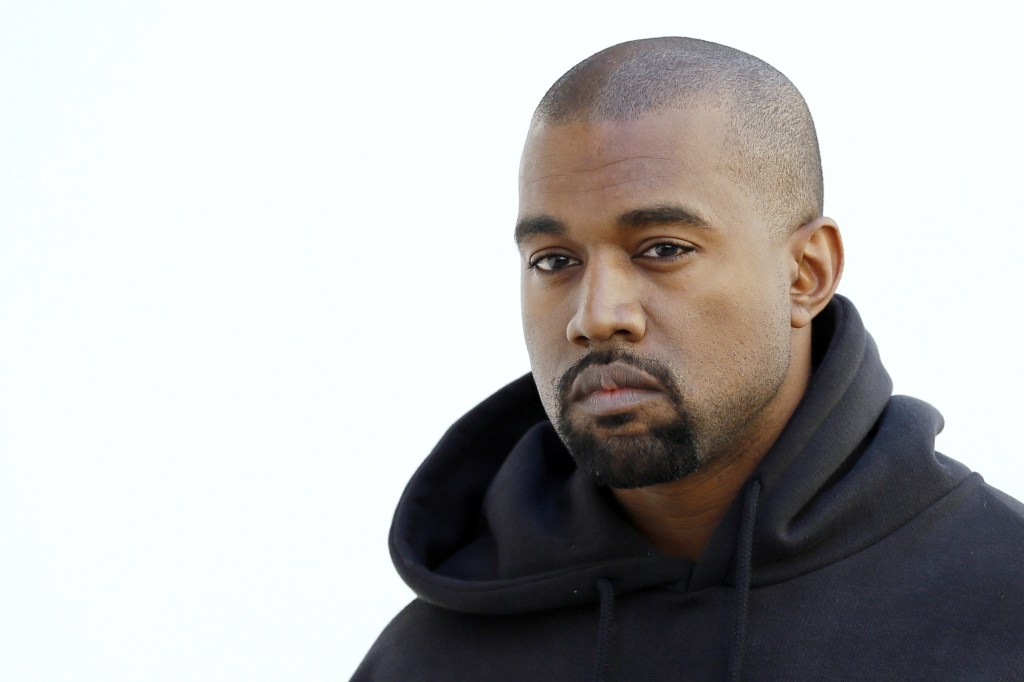 Kanye West wearing a black sweatshirt on a white background, he recently sold his Ford Raptor pickup truck Fleet