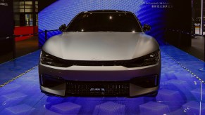 A silver Kia EV6 electric SUV is on display.