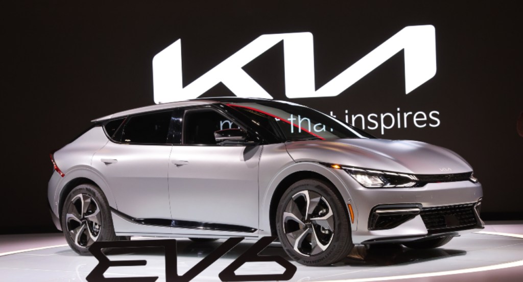 A silver 2022 Kia EV6 electric crossover is on display, its EPA estimated range beats the Ford Mustang Mach-E.