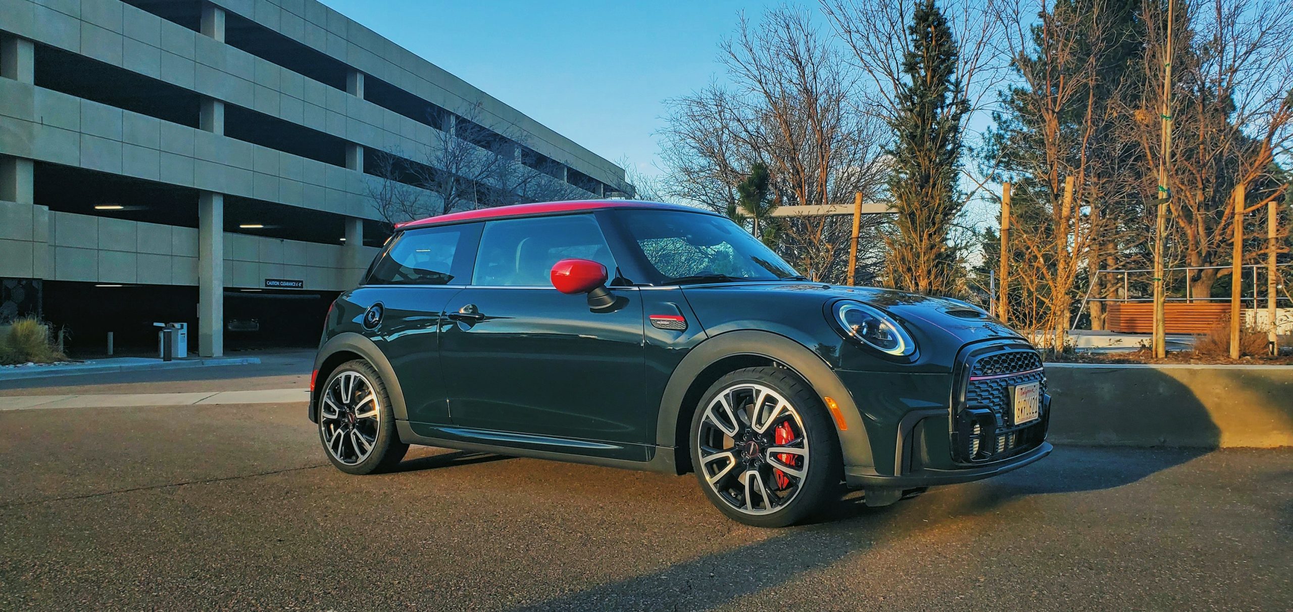 A 2022 Mini Cooper JCW shot from the 3/4 angle at sunset
