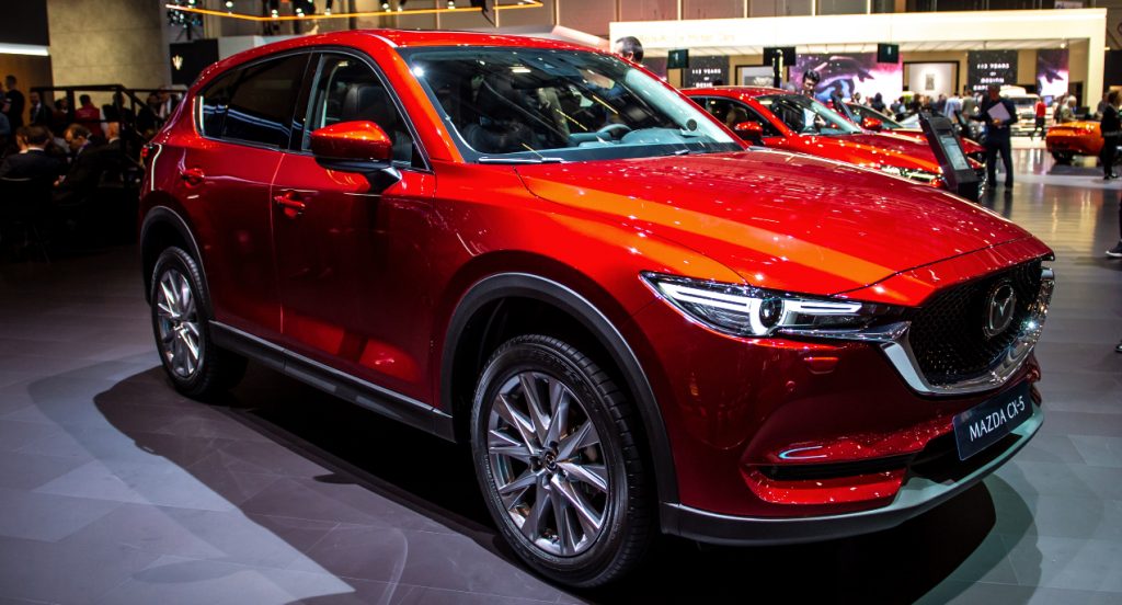 A red Mazda CX-5 is on display.