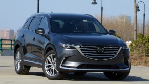 A gray Mazda CX-9 is parked outside.