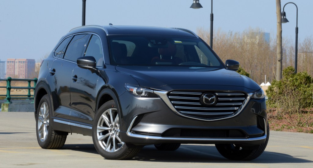 A gray Mazda CX-9 is parked outside.