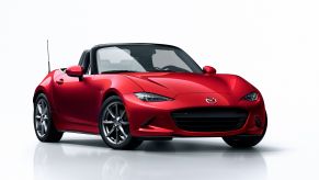 A red Mazda MX-5 on a white background.