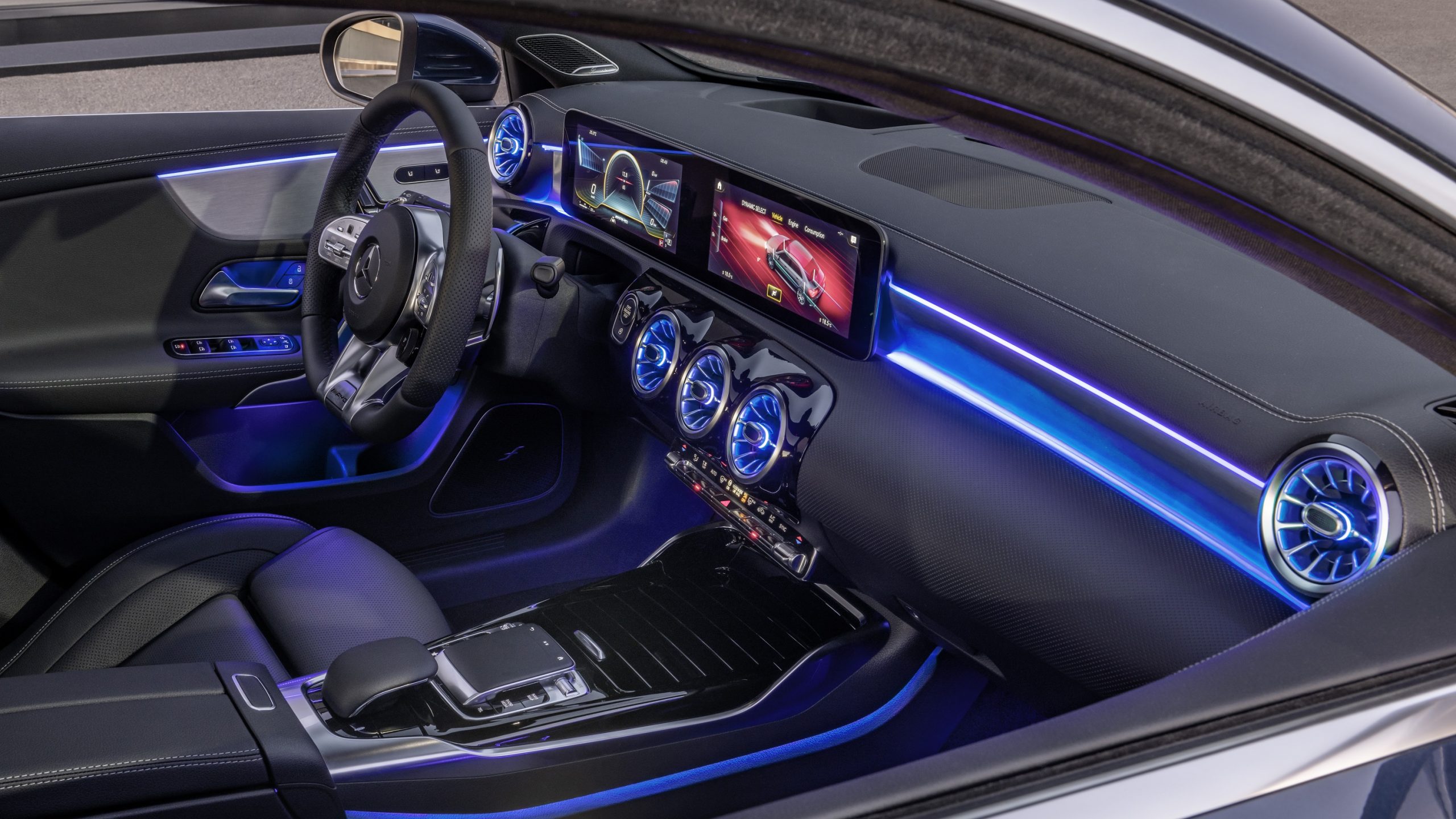 The interior of the Mercedes-AMG A35 sedan with blue ambient lighting