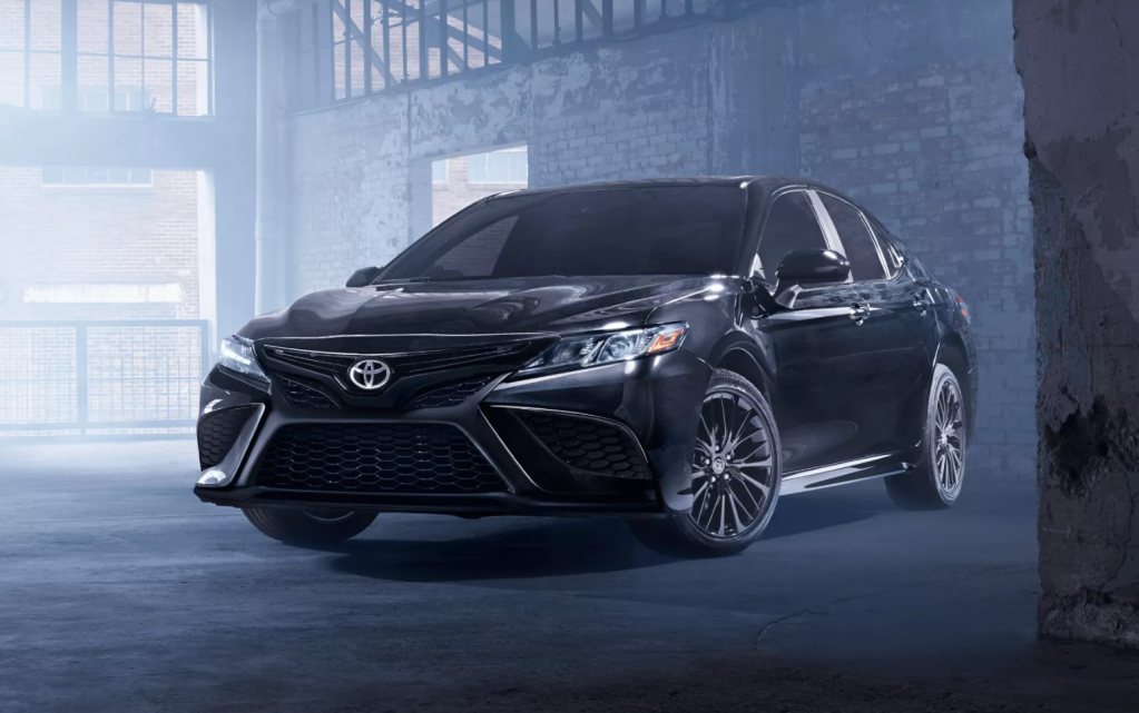 Midnight Black Metallic 2022 Toyota Camry parked inside an old brick building