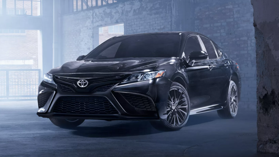 Midnight Black Metallic fully loaded new 2022 Toyota Camry XSE V6 parked in a warehouse