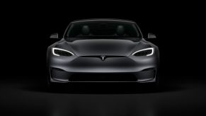 A grey 2022 Tesla Model S Plaid surrounded by shadow in a photo booth