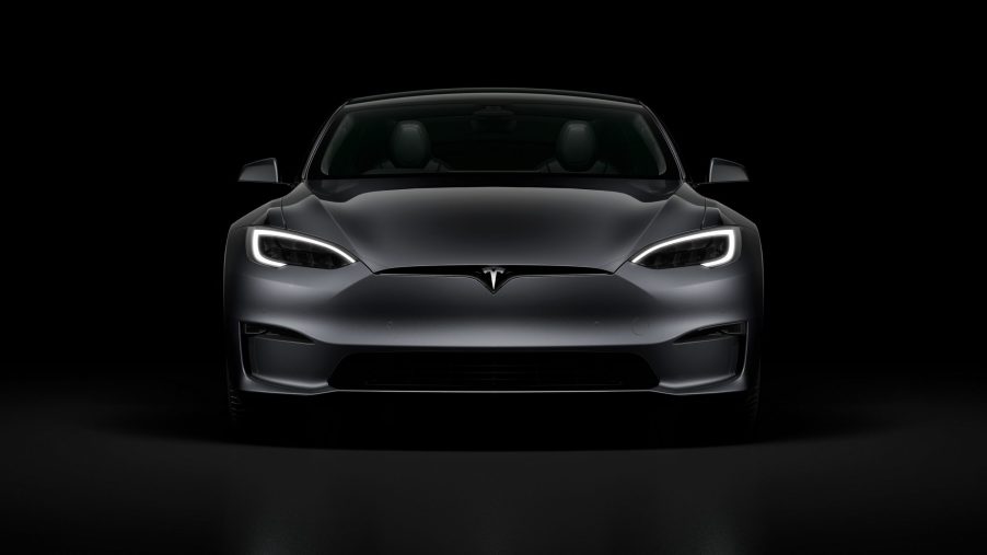 A grey 2022 Tesla Model S Plaid surrounded by shadow in a photo booth