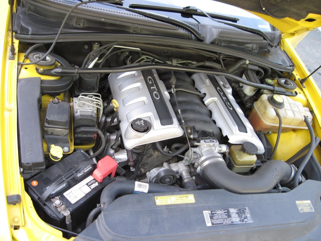The engine bay of a yellow modified 2004 Pontiac GTO