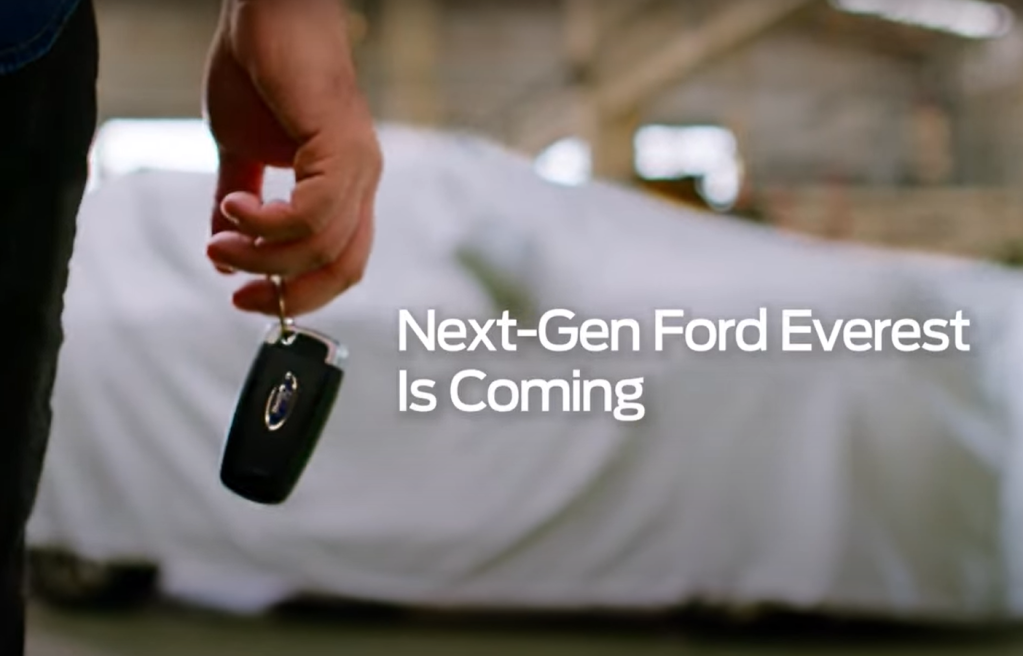 Next-Gen Ford Everest is Coming title with a person holding keys in front of a 2023 Ford Everest