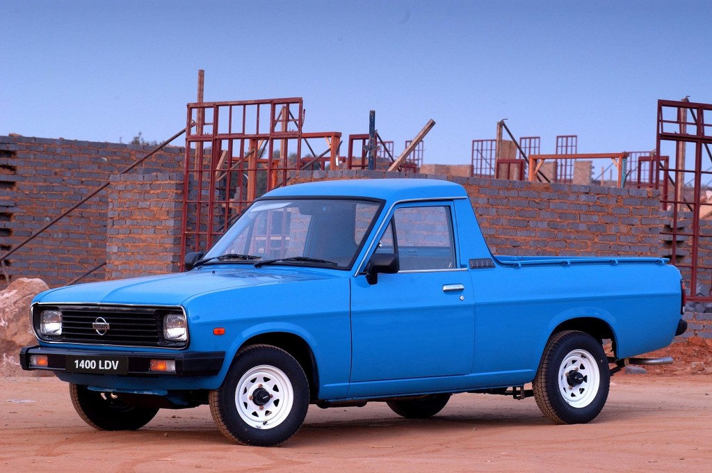 A blue Nissan 1400 'Bakkie' pickup truck in a work site