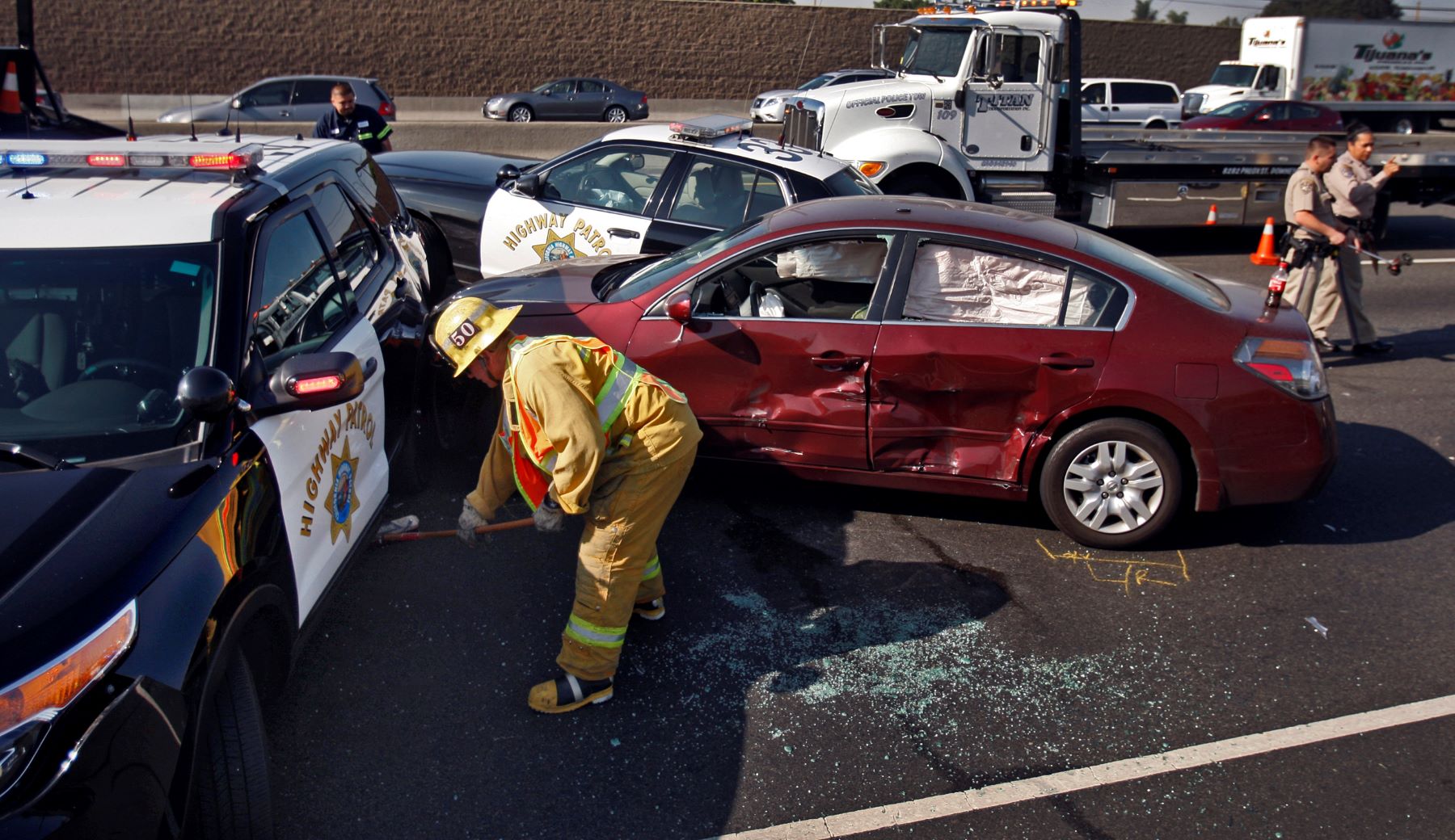 A PIT Maneuver accident aftermath with Los Angeles County firefighter and paramedic teams and California Highway Aptrol officers on-site