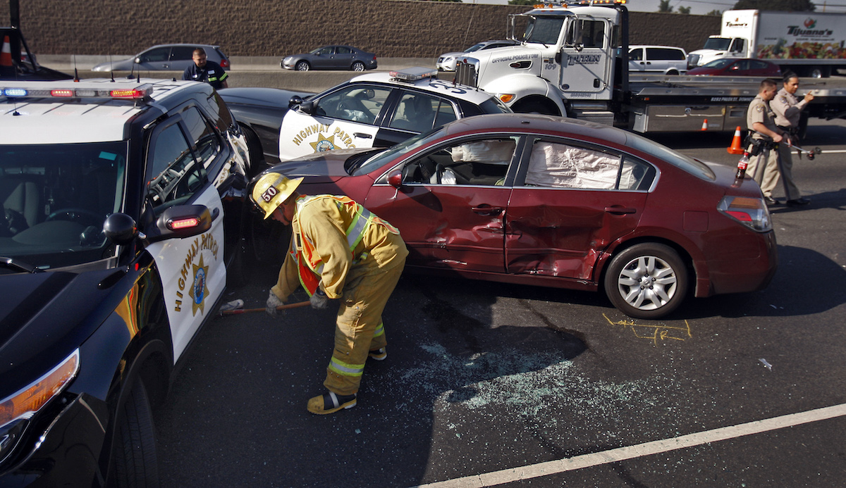 A police PIT maneuver caused a suspect's burgundy Nissan Altima to crash on the Golden State Freeway in Los Angeles on February 24, 2014