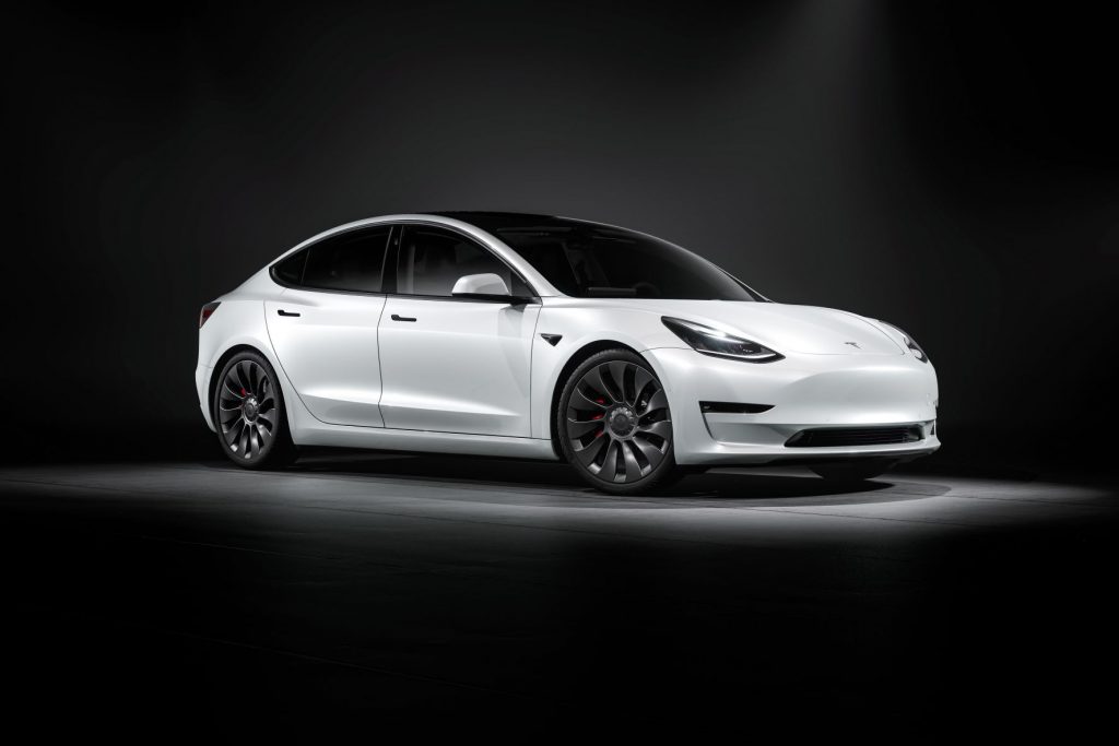 Passenger's side front angle view of white 2021 Tesla Model 3