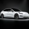 Passenger's side view of white 2022 Tesla Model 3, a car that has high gas mileage and fast acceleration