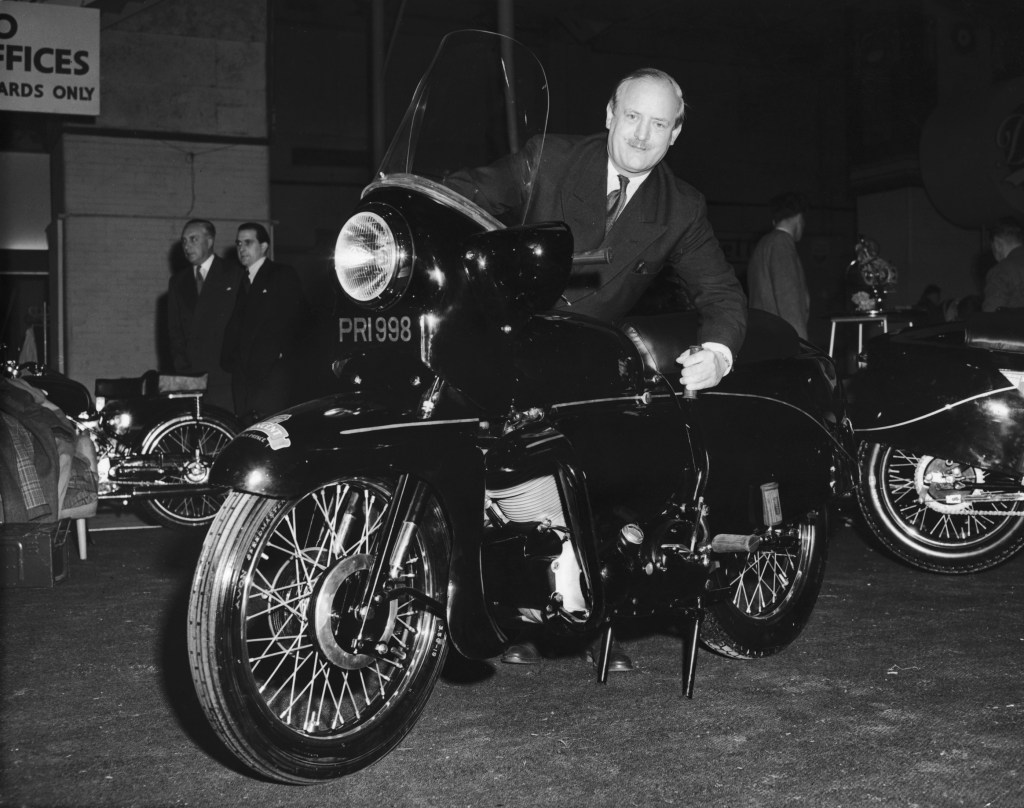 Philip C. Vincent with a 1954 Vincent Black Prince at the 1954 Earl's Court Cycle and Motorcycle Show