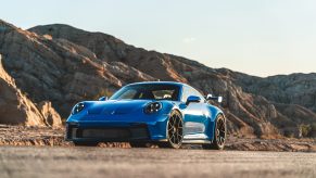 A Shark Blue 2022 Porsche 911 GT3 sports car shot from the front 3/4 in the Angeles forest