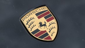 The Porsche logo on the hood of a Cayenne SUV parked on June 13, 2017, in Berlin, Germany