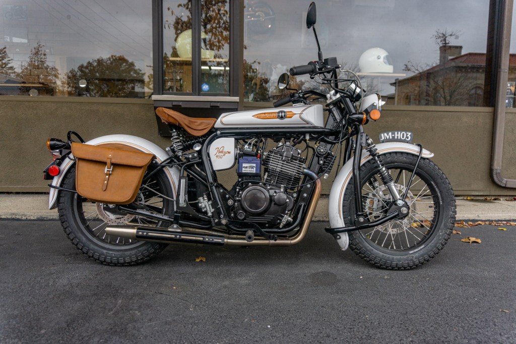 The right side view of a white-and-gold pre-production 2021 Janus Halcyon 450 next to Janus's HQ