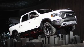 A white Ram 1500 full-size pickup truck is on display.