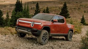 Red Canyon 2022 Rivian R1T driving on a rocky path, showing off its one huge advantage over other EV trucks