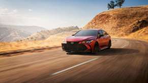 Red 2021 Toyota Avalon TRD driving on a mountain road