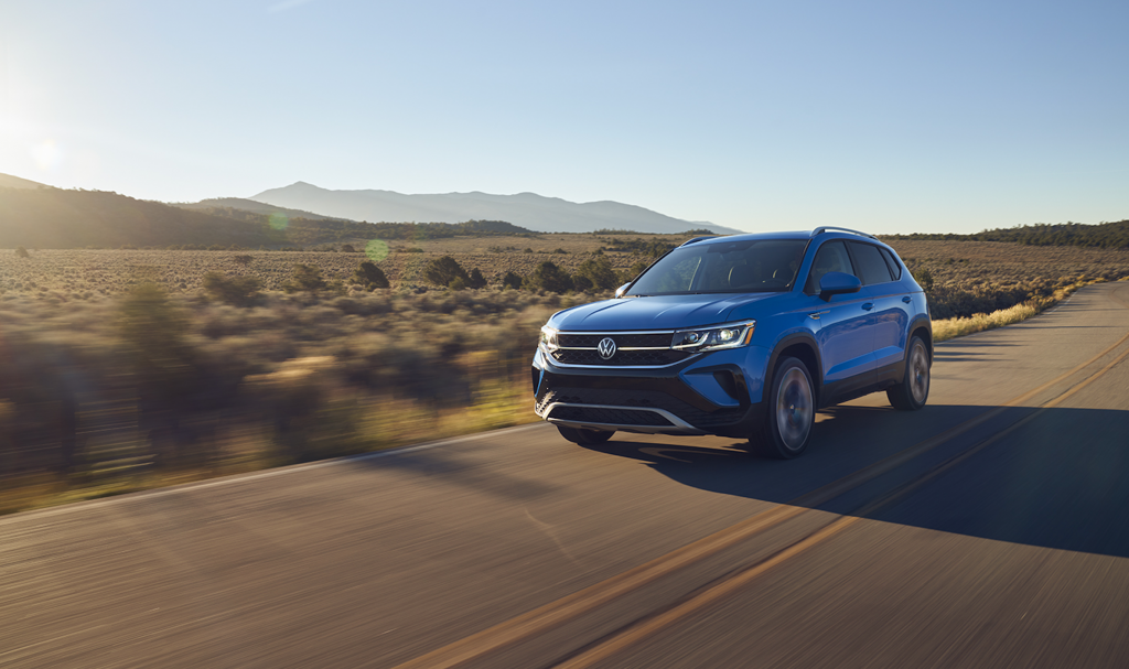 The 2022 Volkswagen Taos driving down the road 