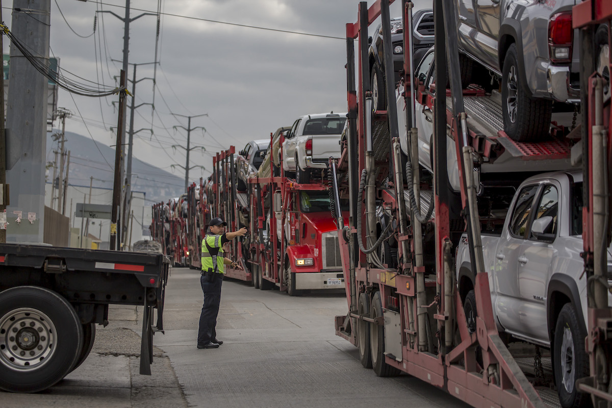 Trucks carrying cars queue in front of the Otay Mesa border crossing in Tijuana in 2019. In some cases, auto parts hide smuggled meth.