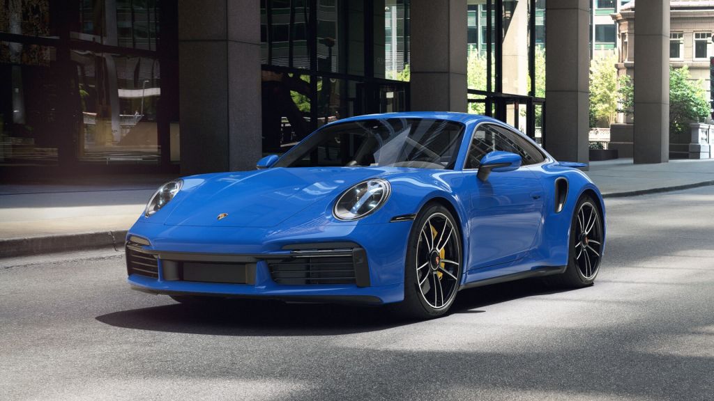 Shark Blue fully loaded 2022 Porsche 911 Turbo S parked near a large building